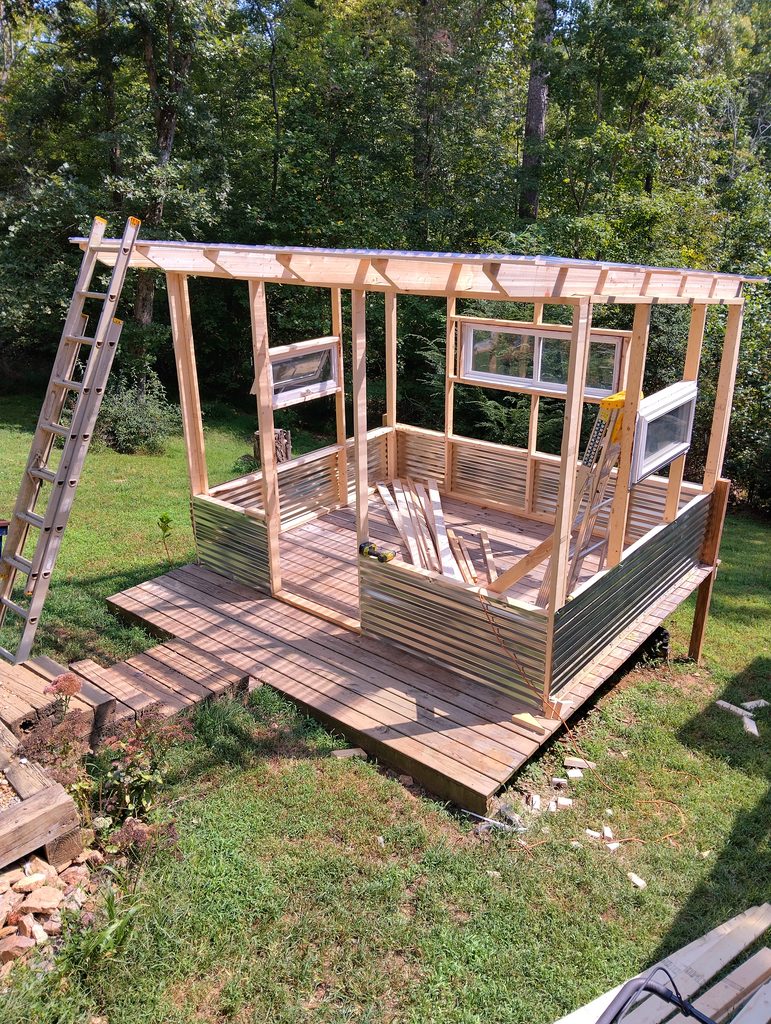 Added some corrugated metal around the base. It matches the pool.